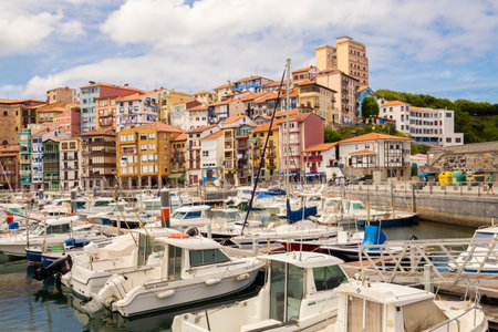 Bermeo, Basque Country, Spain - July 16, 2020: fishing port with colorful facades of houses and fishing boats against the backdrop of a beautiful cloudy skyのeditorial素材