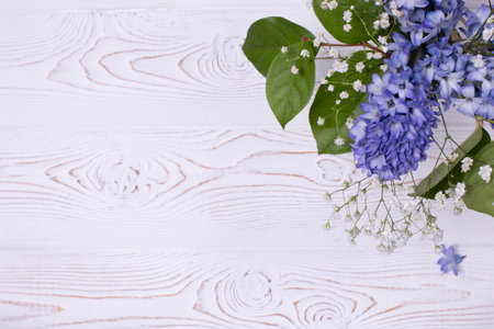 Spring composition with blue hyacinth flowers on a white whitewashed wooden table top. Flat lay. Copy space for textの写真素材