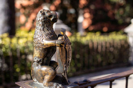 Seville, Andalusia, Spain - January 11, 2019: Bronze statue of a lion holding a coat of arms in the gardens of the Alcazarのeditorial素材