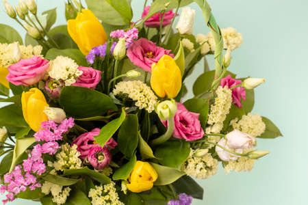 Beautiful multicolored flowers close-up on a green background. Greeting card, moms day, wedding invitation, birthday. Copy of the place.の写真素材