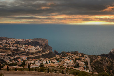 Panoramic view of Cumbre del Sol in Spain, villas on the hills and the sea at sunset, dramatic skyの写真素材