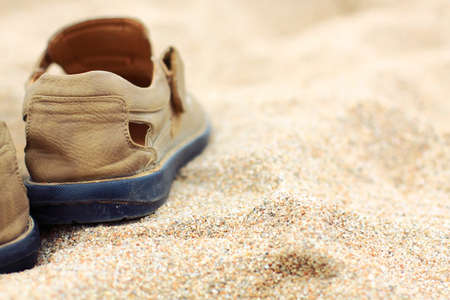 Traveler shoes in the sandの写真素材