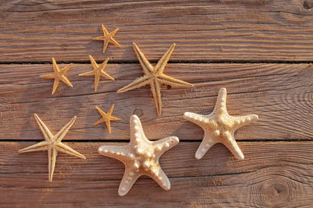 Starfish on a wooden pier poured over a wooden deck. Summer vacation concept. Holidays by the sea....