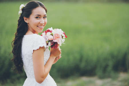 Beautiful bride holds a bouquet in her hands. Wedding. Bridal bouquet. Happy love concept. High quality photoの写真素材