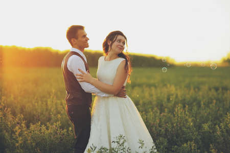 Happy bride and groom in the light of car headlights. Wedding. Happy love concept. High quality photoの写真素材