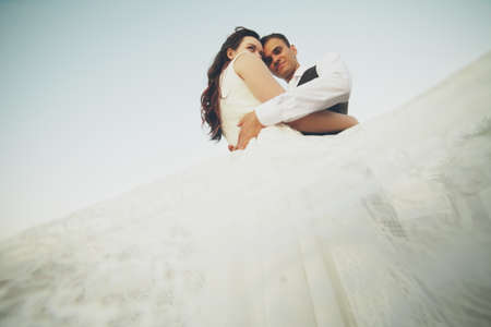 Happy bride and groom in the light of car headlights. Wedding. Happy love concept. High quality photoの写真素材