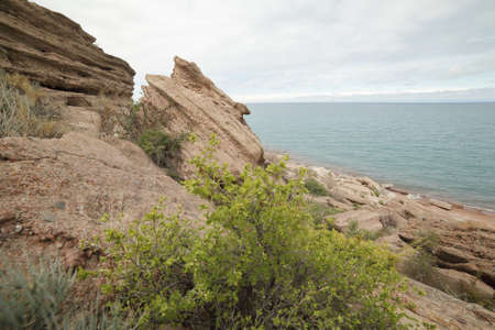 Beautiful mountain landscape. The shore of Lake Issyk-Kul. Wildlife of Kyrgyzstan. Clouds in the sky.の写真素材