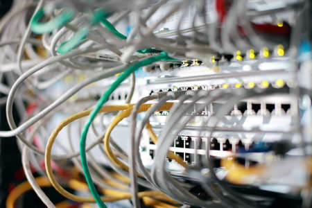 Network Ethernet Cables. Network switch with optical and ethernet connected wires.