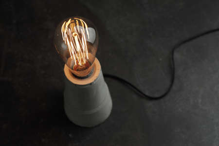 Retro lamp with Edison lamp on concrete. A good ideaの写真素材