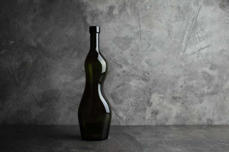 Wine bottle on a concrete background. Free space for inscription.の写真素材