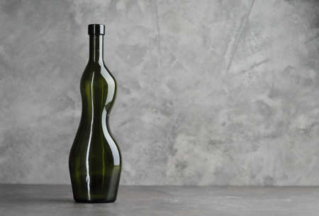 Wine bottle on a concrete background. Free space for inscription.の写真素材