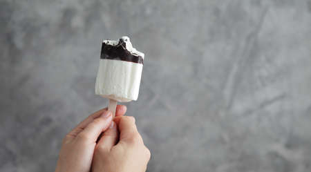 Ice cream in a female hand. Sweet dessertの写真素材