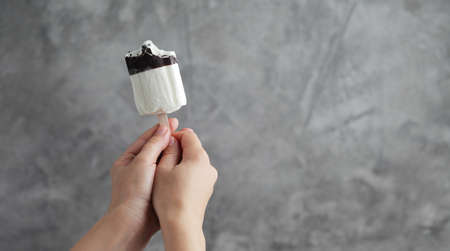 Ice cream in a female hand. Sweet dessertの写真素材