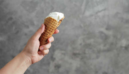 Ice cream in a female hand. Sweet dessertの写真素材