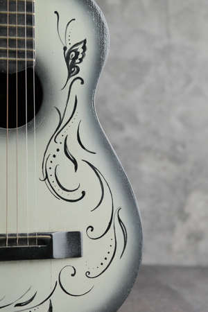 Vintage ladies antique guitar on a concrete baseの写真素材