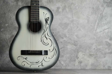 Vintage ladies antique guitar on a concrete baseの写真素材