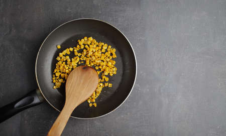 Diet. Organic Grilled Corn in a frying pan. Organic farm vegetables. Gray background Top view. Wooden spoon. Vegetarian food. Environmentally friendly productsの写真素材