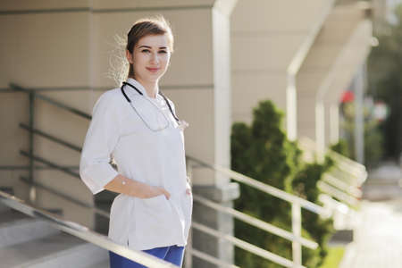 Portrait of a beautiful female doctor or nurse. Prevention Covid-19 healthcare concept. Stethoscope over the neck. Woman, girl.の写真素材