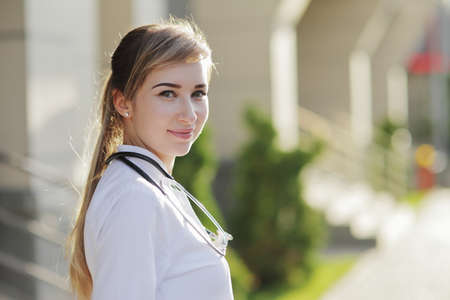 Portrait of a beautiful female doctor or nurse. Prevention Covid-19 healthcare concept. Stethoscope over the neck. Woman, girl.の写真素材
