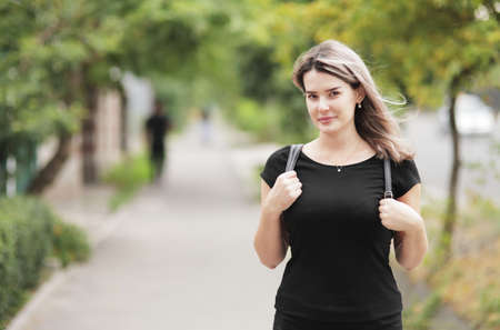 Fashion portrait of young stylish woman walking down the street, in trendy outfit, traveling with a backpack. High quality photoの写真素材