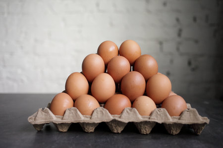 Full tray with chicken egg on white wall background. High quality photoの写真素材