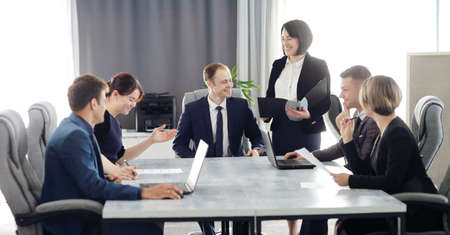 Group of young business people meeting in the office having fun together discussing an ideaの写真素材