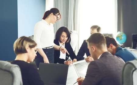 Group of young business people meeting in the office having fun together discussing an idea.の写真素材