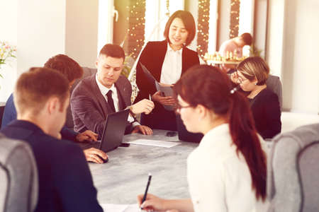 Group of young successful businessmen lawyers communicating together in a conference room while working on a project.の写真素材