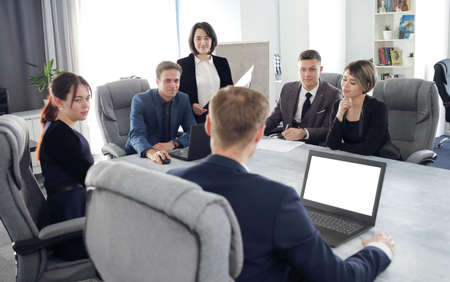 Group of young business people meeting in the office discussing an important idea together.