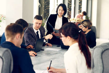Group of young successful businessmen lawyers communicating together in a conference room while working on a project.の写真素材