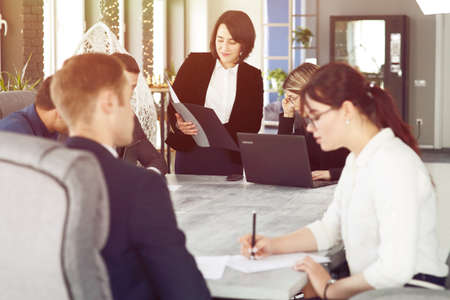 Group of young successful businessmen lawyers communicating together in a conference room while working on a project.の写真素材