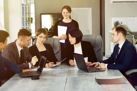 Group of young business people meeting in the office discussing an important idea together.の写真素材