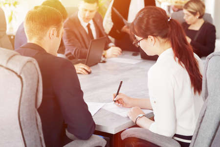 Group of young successful businessmen lawyers communicating together in a conference room while working on a projectの写真素材