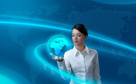 Attractive brunette holding virtual globe (outstanding business people in interiors / interfaces series)の写真素材
