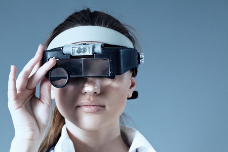Young female doctor wearing magnifying glass equipment on her had  Medical   pharmaceutical research concept  Healthcare collection の写真素材