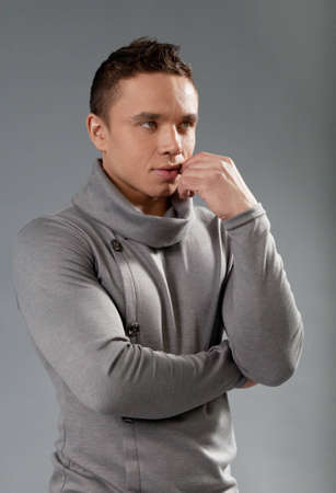 Sexy thinking fit and neat young man in studio  Wearing grey turtleneck sweater  Fit and neat collection の写真素材