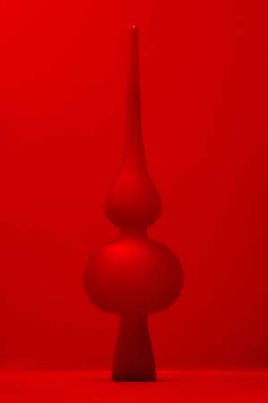 New Years toy hovering in the air on a red backgroundの写真素材