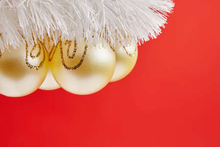 Christmas golden toys for greeting card on the red backgroundの写真素材