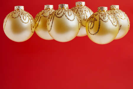 Christmas golden toys for greeting card on the red backgroundの写真素材