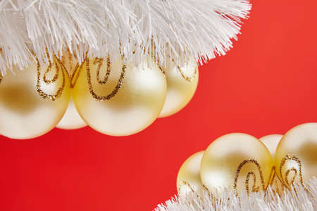 Christmas golden toys for greeting card on the red backgroundの写真素材