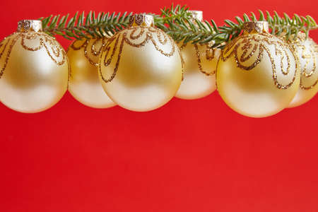 Christmas golden toys for greeting card on the red backgroundの写真素材