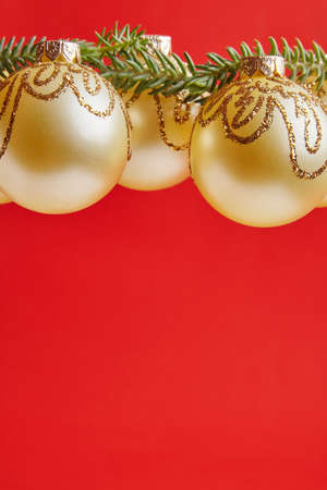 Christmas golden toys for greeting card on the red backgroundの写真素材