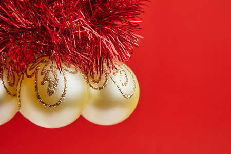 Christmas golden toys for greeting card on the red backgroundの写真素材