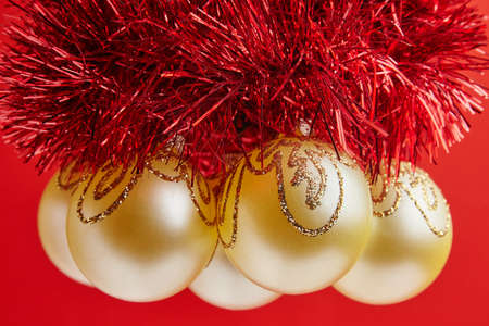 Christmas golden toys for greeting card on the red backgroundの写真素材