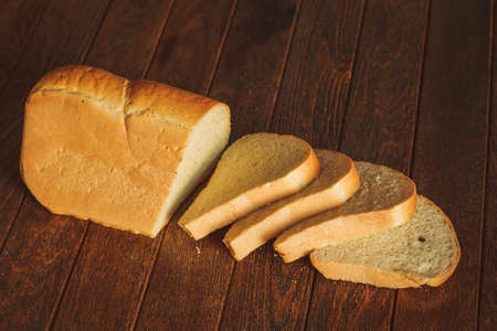 Slices of bread on dark wooden background