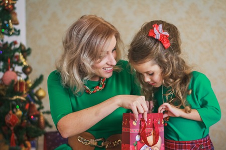 Mother with daughter with the new year gift in studioの写真素材