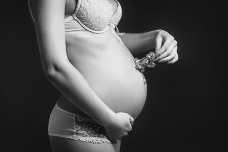 Pretty pregnant belly with small angelの写真素材