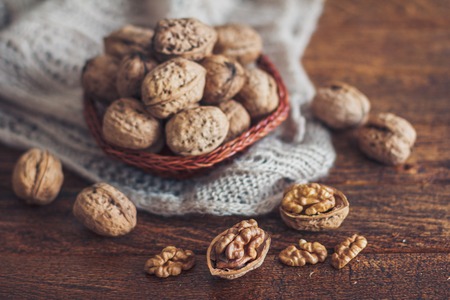 Walnuts on dark wooden background
