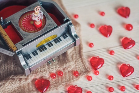 Music box with little ballerina with red hearts  on light backgroundの写真素材