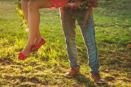 Swinging legs of two young people on datingの写真素材